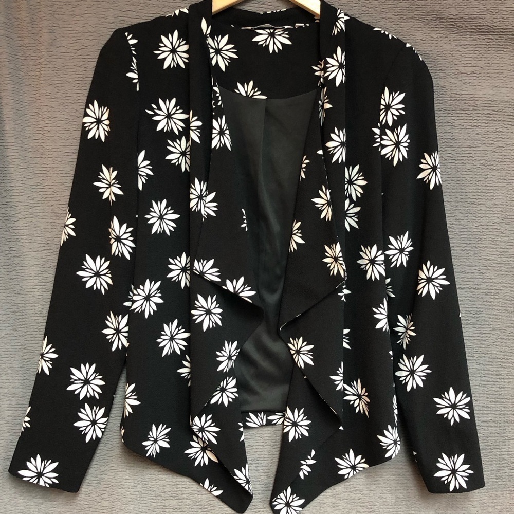 Red herring 10 jacket, black and white with flowers has waterfall ruffles front